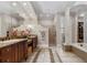 Luxurious main bathroom with dual sinks, a soaking tub, a separate shower, and plenty of storage space at 6149 Blakeford Dr, Windermere, FL 34786