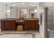 Elegant main bathroom with dual sinks, granite countertops, a soaking tub, and modern fixtures for a spa-like experience at 6149 Blakeford Dr, Windermere, FL 34786