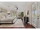 Relaxing main bedroom with hardwood floors, ceiling fan, and access to a private balcony overlooking the backyard at 6149 Blakeford Dr, Windermere, FL 34786