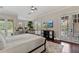 Bright main bedroom with hardwood floors, natural light, a ceiling fan, and access to a private balcony at 6149 Blakeford Dr, Windermere, FL 34786