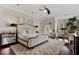 Comfortable main bedroom with hardwood floors, a ceiling fan, and ample natural light from the windows at 6149 Blakeford Dr, Windermere, FL 34786
