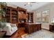 Beautiful home office with custom cabinetry, hardwood floors, and a cozy sitting area at 6149 Blakeford Dr, Windermere, FL 34786