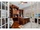 Spacious home office featuring custom wood built-ins, a large desk, and hardwood floors at 6149 Blakeford Dr, Windermere, FL 34786