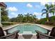 Relaxing pool view with comfortable outdoor seating and lush tropical landscaping at 6149 Blakeford Dr, Windermere, FL 34786