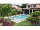 Inviting pool area with fountain, surrounding patio, palm trees and lush landscaping at 6149 Blakeford Dr, Windermere, FL 34786