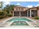 Stunning backyard with a large pool, spa, screened patio, and lush tropical landscaping at 6149 Blakeford Dr, Windermere, FL 34786