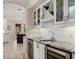 Stylish wet bar features granite countertops, a wine rack, and a sink at 6149 Blakeford Dr, Windermere, FL 34786