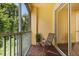 Balcony with two chairs overlooking lush greenery at 6335 Contessa Dr # 208, Orlando, FL 32829