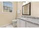 Bathroom with granite countertops, vanity, and mirror at 6335 Contessa Dr # 208, Orlando, FL 32829
