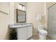 Bathroom featuring a granite countertop vanity, framed mirror, toilet, and glass-enclosed shower at 6335 Contessa Dr # 208, Orlando, FL 32829