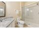 Bathroom featuring a granite countertop vanity, toilet, and glass-enclosed shower at 6335 Contessa Dr # 208, Orlando, FL 32829