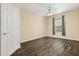 Cozy bedroom with a ceiling fan, wood floors, and a window providing natural light at 6335 Contessa Dr # 208, Orlando, FL 32829