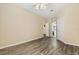 Bedroom with an open ensuite bathroom and wood floors at 6335 Contessa Dr # 208, Orlando, FL 32829