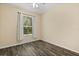 Bedroom featuring a window providing natural light and wood floors at 6335 Contessa Dr # 208, Orlando, FL 32829