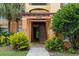 Condo building entrance featuring well-kept landscaping, stairs, and clearly marked unit numbers for easy access at 6335 Contessa Dr # 208, Orlando, FL 32829