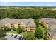 A serene view of the yellow and orange Horizon complex in a lush, green, landscaped setting at 6335 Contessa Dr # 208, Orlando, FL 32829