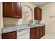 Well-lit kitchen showcasing granite countertops, modern fixtures, and seamless transition to adjacent spaces at 6335 Contessa Dr # 208, Orlando, FL 32829