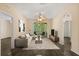Staged living room showcasing modern decor, balcony access, and wood-look floors at 6335 Contessa Dr # 208, Orlando, FL 32829