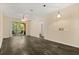 Bright living room featuring a ceiling fan, modern light fixture, wood floors, and a sliding glass door to the balcony at 6335 Contessa Dr # 208, Orlando, FL 32829