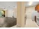 Open floor plan showcasing kitchen with granite counters, laminate flooring, and a view of the outdoor balcony at 6335 Contessa Dr # 208, Orlando, FL 32829