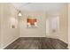 Inviting living area with an open layout, smooth walls, and stylish laminate flooring and kitchen view at 6335 Contessa Dr # 208, Orlando, FL 32829