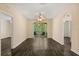 Bright living room featuring laminate flooring, neutral walls, and access to a balcony with serene views at 6335 Contessa Dr # 208, Orlando, FL 32829