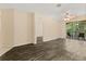 Spacious living area with laminate flooring, balcony access, and an open doorway, offering seamless transitions at 6335 Contessa Dr # 208, Orlando, FL 32829