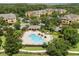 Aerial view of community pool surrounded by trees at 6335 Contessa Dr # 208, Orlando, FL 32829