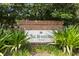 A brick sign that reads, 'The Horizons at Vista Lakes' surrounded by lush greenery and manicured plants at 6335 Contessa Dr # 208, Orlando, FL 32829