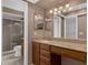 Bathroom boasting granite vanity, wood drawers, single sink, and shower with glass door at 817 Big Buck Cir, Winter Springs, FL 32708