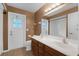 Bathroom featuring double sink vanity, toilet, and shower reflected in a large mirror at 817 Big Buck Cir, Winter Springs, FL 32708