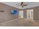 This bedroom features a ceiling fan, carpeted floors, and a wall-mounted television at 817 Big Buck Cir, Winter Springs, FL 32708