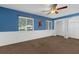 A blue bedroom features a ceiling fan, carpeted floors, and a closet at 817 Big Buck Cir, Winter Springs, FL 32708