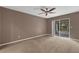 This bedroom features a ceiling fan, carpeted floors, and sliding glass doors to the porch at 817 Big Buck Cir, Winter Springs, FL 32708