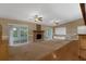 Spacious living room features carpet flooring, vaulted ceiling, fireplace, and sliding doors to outdoor patio at 817 Big Buck Cir, Winter Springs, FL 32708