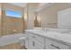 Bathroom featuring a large mirror, white cabinet, double sinks, and shower/tub combo at 8348 Vivaro Isle Way, Windermere, FL 34786