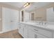 Bathroom with double vanity and undermount sinks under a large mirror at 8348 Vivaro Isle Way, Windermere, FL 34786