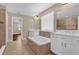 Bright bathroom featuring a soaking tub, tiled shower, and double vanity at 8348 Vivaro Isle Way, Windermere, FL 34786