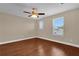 Bright bedroom features a ceiling fan and two windows for natural light and wood-look floors at 8348 Vivaro Isle Way, Windermere, FL 34786