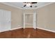 Bedroom with hardwood floors, neutral walls, and a doorway to another room, showcasing a cozy atmosphere at 8348 Vivaro Isle Way, Windermere, FL 34786