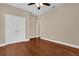 Bedroom features wood flooring, neutral walls, a ceiling fan, and closet space at 8348 Vivaro Isle Way, Windermere, FL 34786