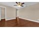 Spacious bedroom offers wood-look floors, a ceiling fan, and a closet for ample storage at 8348 Vivaro Isle Way, Windermere, FL 34786