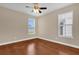 Bright bedroom with two windows and neutral paint and flooring at 8348 Vivaro Isle Way, Windermere, FL 34786