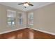 Bright bedroom with hardwood floors, three windows offering ample natural light, and fresh paint at 8348 Vivaro Isle Way, Windermere, FL 34786