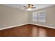 Inviting bedroom with wood-look floors, ceiling fan, and windows create a comfortable space at 8348 Vivaro Isle Way, Windermere, FL 34786