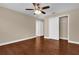 Bedroom boasts wood-look floors, a ceiling fan, and a closet for storage, offering comfort and style at 8348 Vivaro Isle Way, Windermere, FL 34786