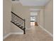 Inviting foyer featuring tile floors, stairs, and an open view to the living space beyond at 8348 Vivaro Isle Way, Windermere, FL 34786