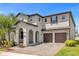Stunning two-story home with a two-car garage, arched entrance, and beautifully landscaped front yard at 8348 Vivaro Isle Way, Windermere, FL 34786