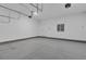 Finished garage featuring a painted floor and door to the outside at 8348 Vivaro Isle Way, Windermere, FL 34786