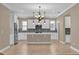 Modern kitchen featuring white cabinetry, stainless steel appliances, a kitchen island, and stylish backsplash at 8348 Vivaro Isle Way, Windermere, FL 34786
